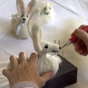 Photo of a person needlefelting an animal