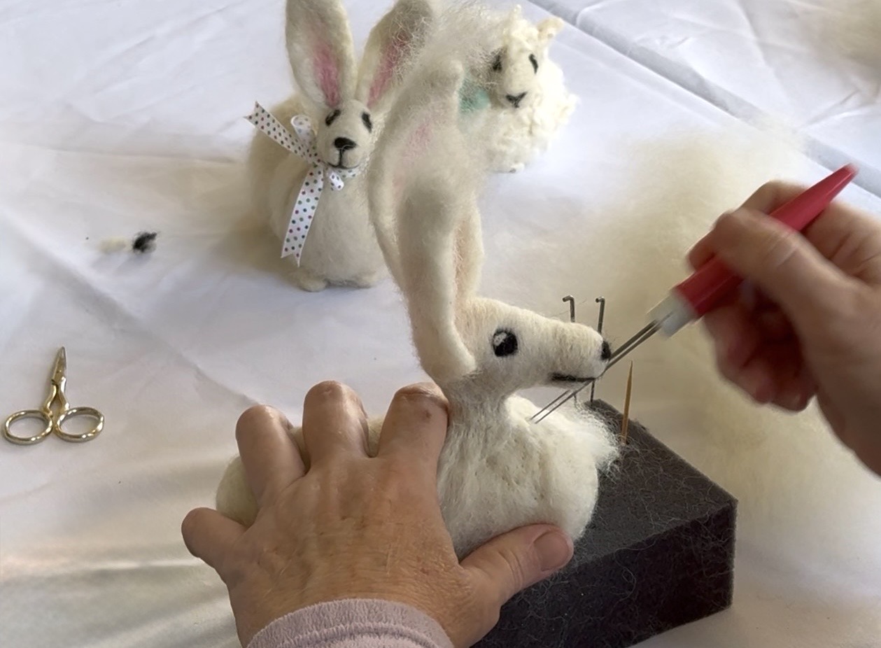 Photo of a person needlefelting an animal